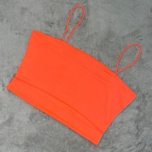 Neon orange top with a slit in between the shirt